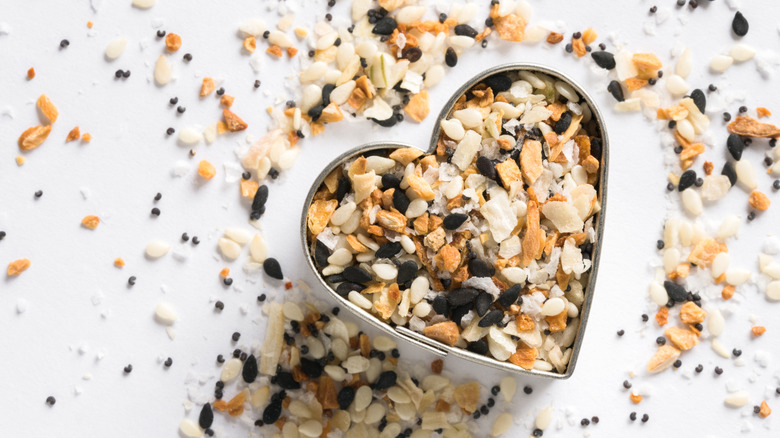 Everything bagel seasoning in an open heart-shaped container