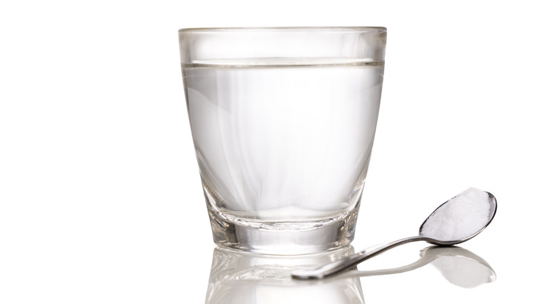glass of water and spoon of salt