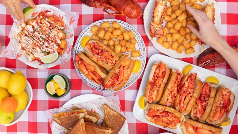 cousins maine lobster menu items spread on picnic table