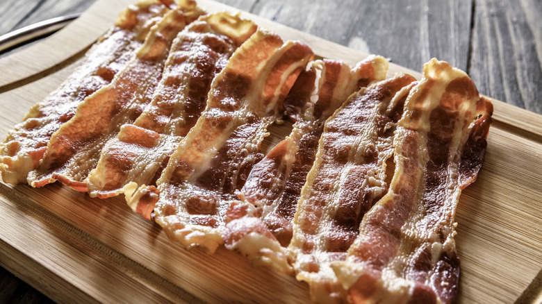 bacon strips on wooden board