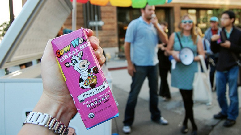 Hand holding Cow Wow cereal milk