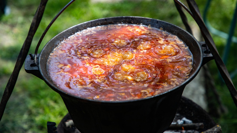 Chili con carne boiling in an outdoor cauldron