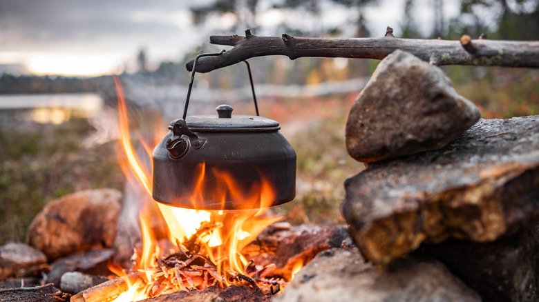 Coffee pot boiling over an open flame