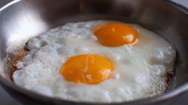 sunny side up eggs in a frying pan