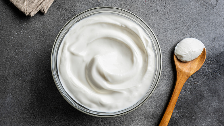 Bowl of Greek yogurt with wooden spoon