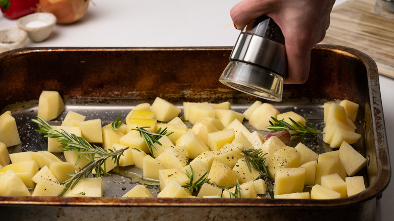 raw potato cubes on baking sheet
