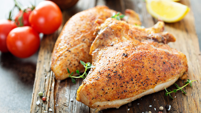Chicken legs on chopping board