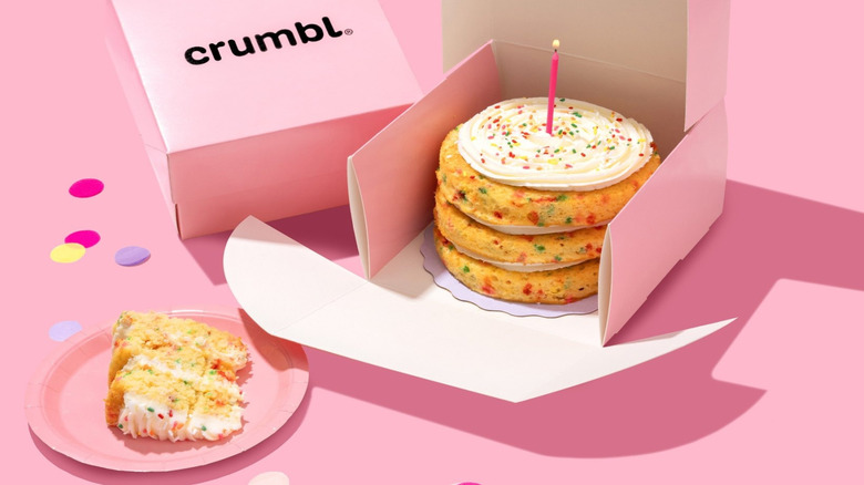 A Crumbl confetti cake sits in its signature pink box