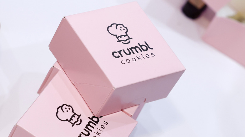 Crumbl cookies boxes on white table