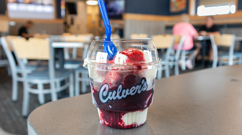 A Culver's strawberry sundae sits on a restaurant counter