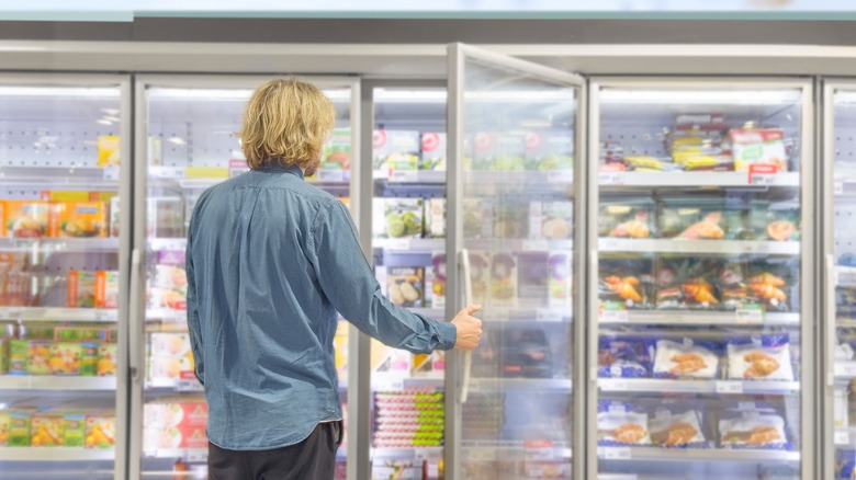 Man shopping in a freezer aisle