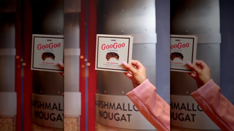 Hand holding a box of Goo Goo Clusters