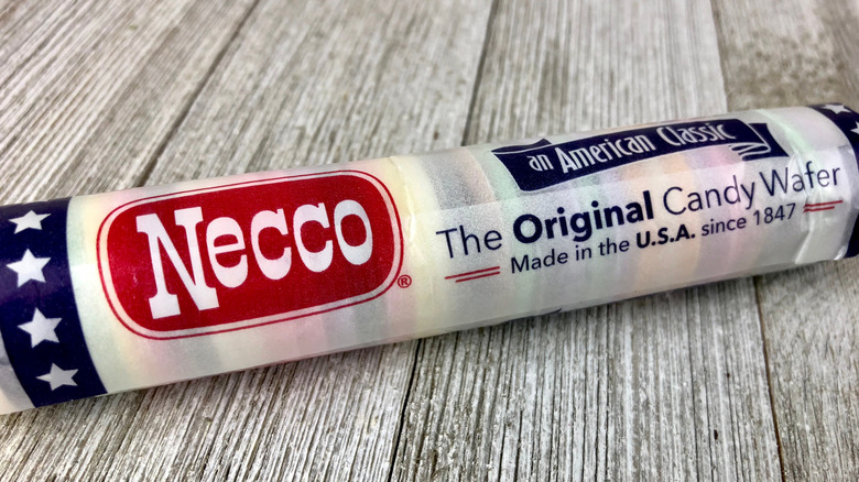 A package of Necco Wafers on a wood background.