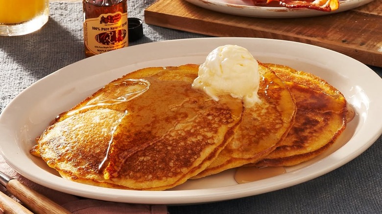 Cracker Barrel's Buttermilk Pancakes with a dollop of butter and Cracker Barrel's syrup