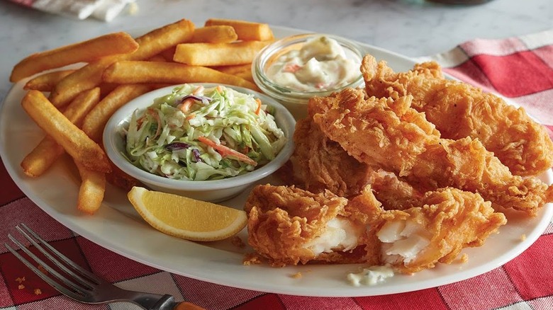 Cracker Barrel's Friday Fish Fry with coleslaw, tartar sauce, a slice of lemon, and steak fries