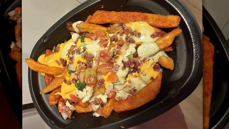 A to-go plate of Taco Bell's chicken bacon ranch nacho fries