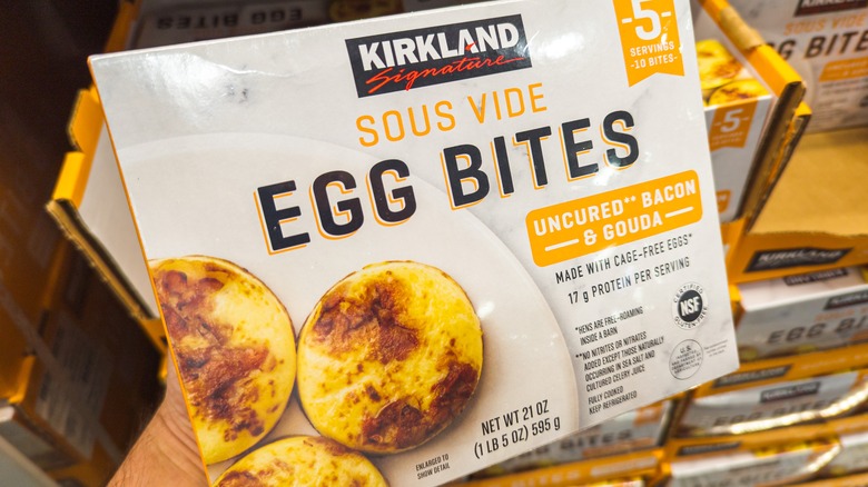 A box of Kirkland sous vide egg bites placed in front of cartons stocked with more egg bites.