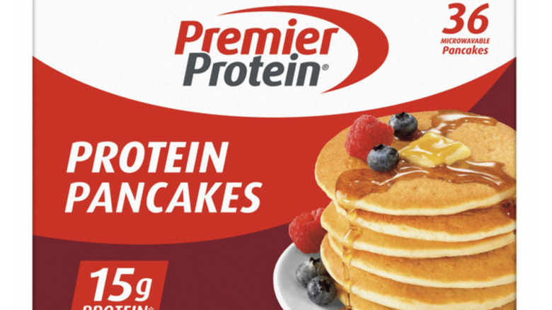Premeir protein's label next to a stack of pancakes with syrup, butter, and fruit.