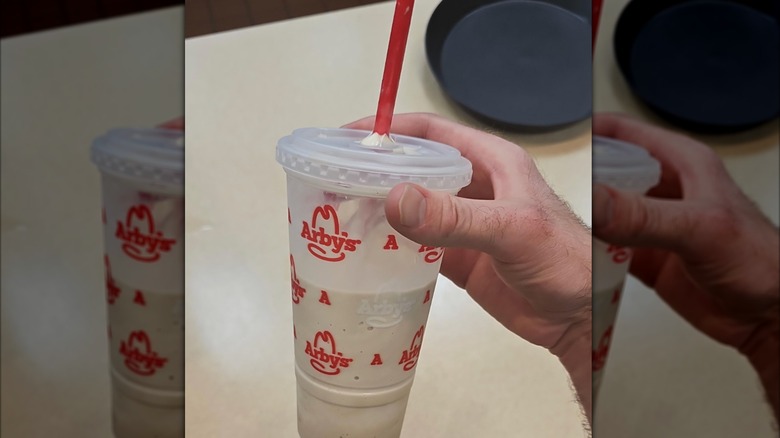 Hand holding an Arby's Jamocha shake