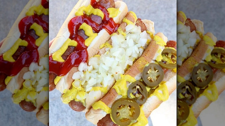 A trio of hot dogs with a variety of garnishes from RaceTrac