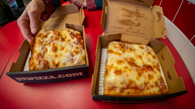 Two personal cheese pizzas in to-go boxes at Jet's Pizza
