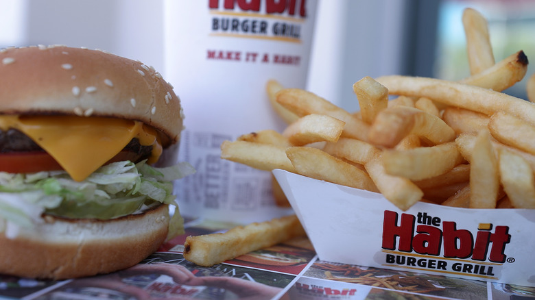 A cheeseburger and fries sit next to a soda at the Habit Burger Grill