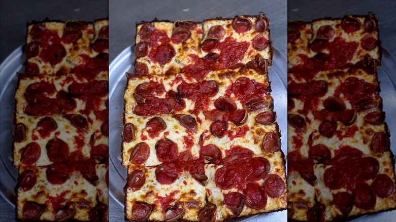 Detroit-style pizza on a silver tray.