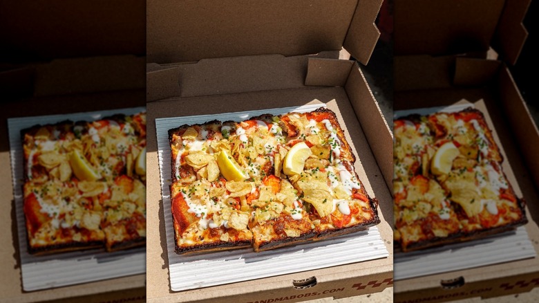 Grandma Bob's Detroit-style lobster pizza on a cardboard box.