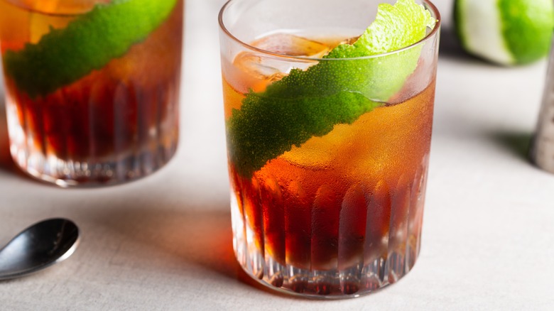 cynar cocktails with lime zest on white table