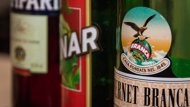 bottles of amaro on a shelf