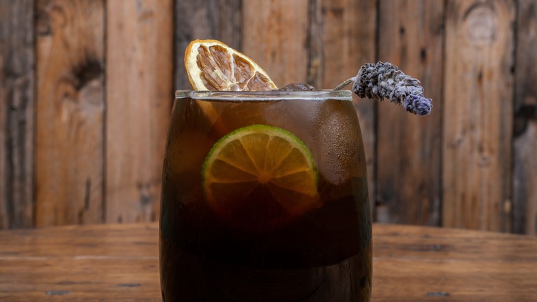 Cynar cocktail with lavender and orange garnish