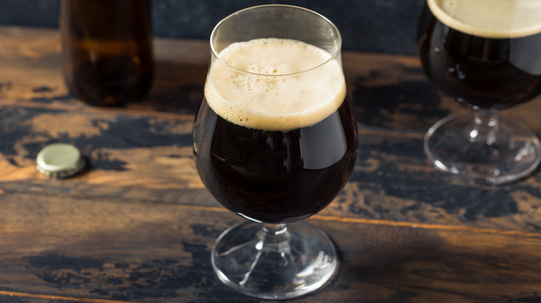 A foamy glass of dark beer