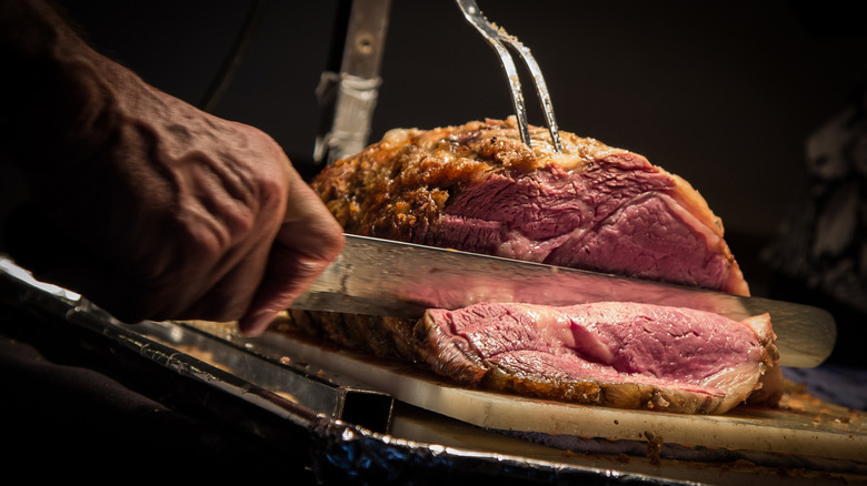 Carving prime rib into slices