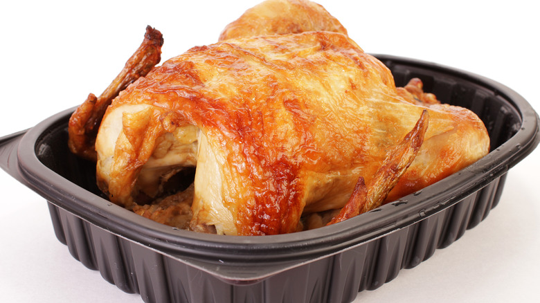 rotisserie chicken in black takeout container