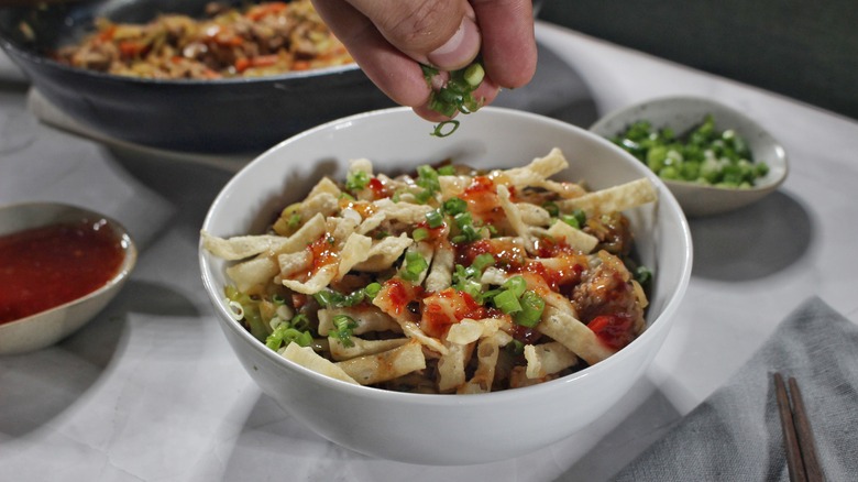 garnishing deconstructed egg roll bowl