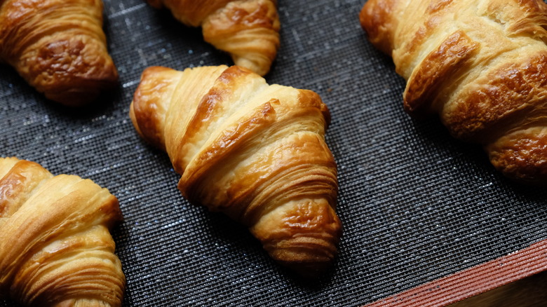 golden buttery croissants on tray