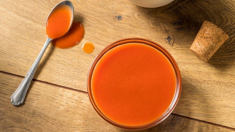 Glass ramekin of buffalo sauce