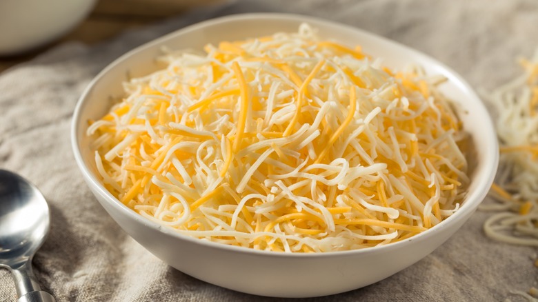 Ceramic bowl of shredded cheese