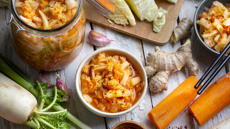 Containers of kimchi with ingredients