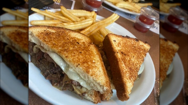 a Big Dipper Melt on a plate at Denny's with a side of fries.