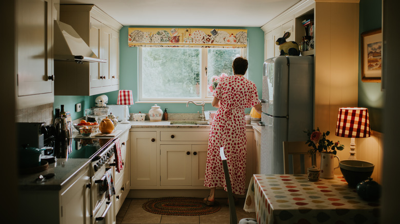 Person in retro-looking kitchen with colorful accents