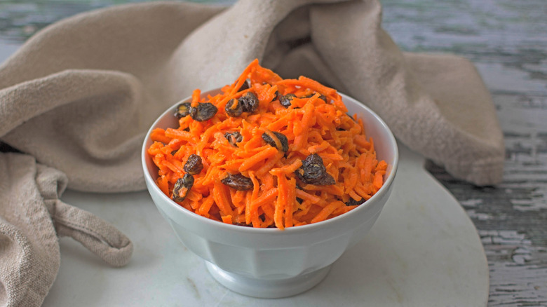 Served bowl of carrot raisin salad.