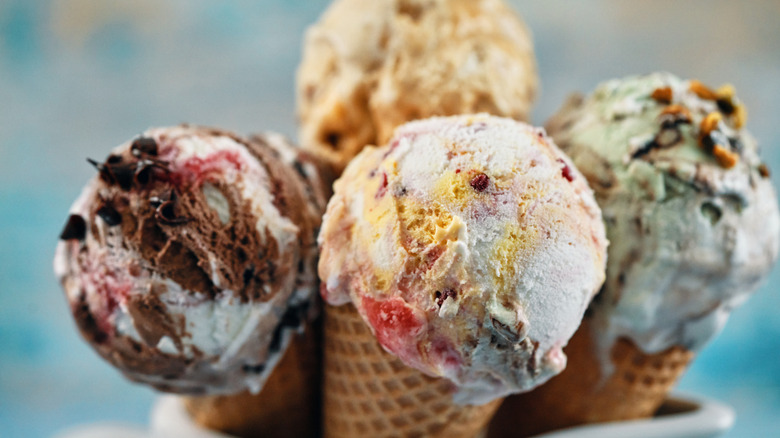 four ice cream scoops in waffle cones