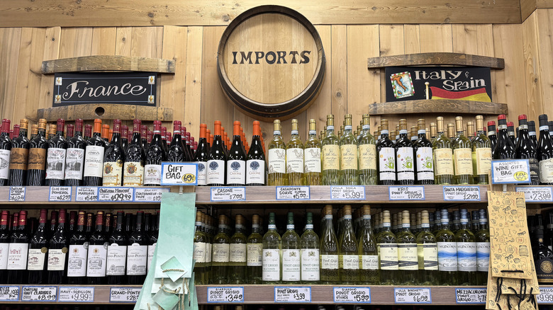 Large selection of various imported wines on shelf at Trader Joe's.