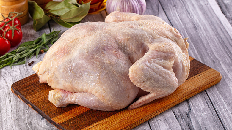 A whole raw chicken.