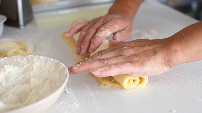 Person rolling out lemon rolls 
