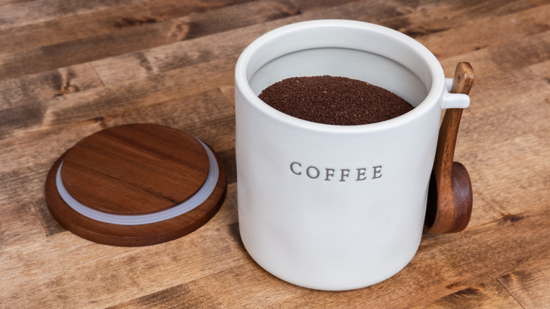 Open canister of ground coffee