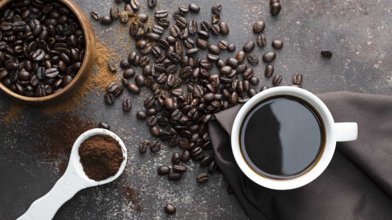 Beans, freshly-ground, and cup of coffee