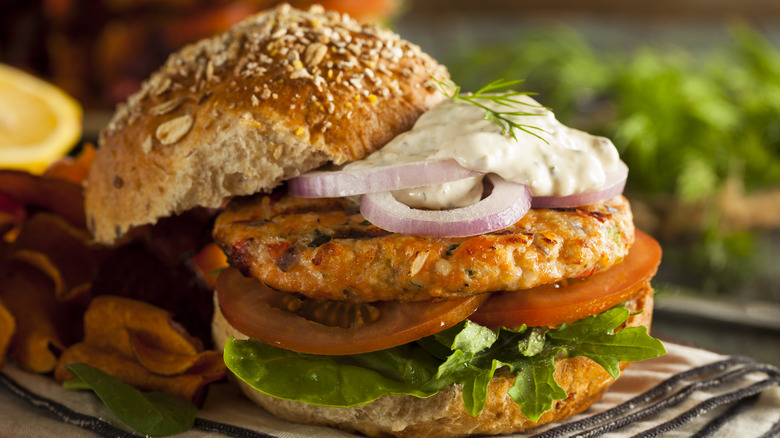 Salmon burger on bun with sauce