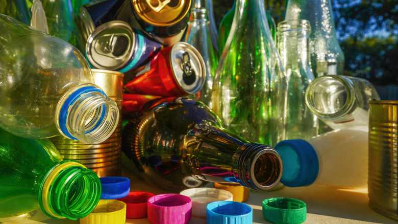 Bottles and cans in a pile on a table